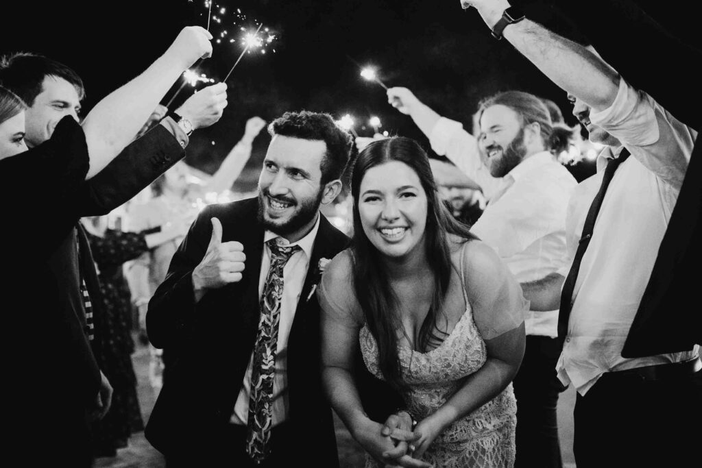Bride and groom celebrating during a sparkler exit at Chapel Farm, a top Swan Valley wedding venue.