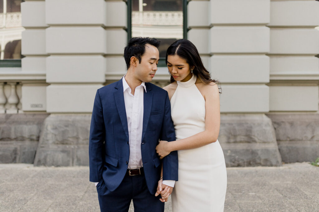 Couple in formal attire during an elegant pre-wedding shoot in Perth’s city architecture.