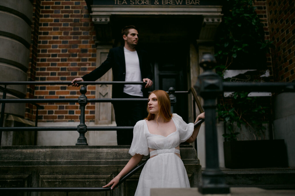 Couple posing near a vintage tea bar during their stylish Perth city pre-wedding shoot.