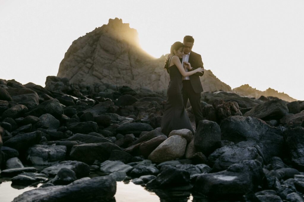 Couple embracing among rocks at Sugarloaf Rock during a pre-wedding shoot — an adventurous location in Western Australia.