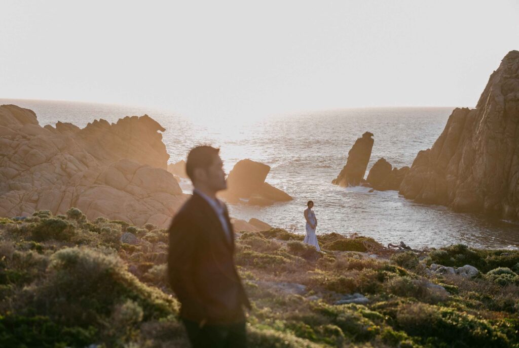 Bride and groom at sunset near Sugarloaf Rock, one of Western Australia’s most adventurous pre-wedding locations.