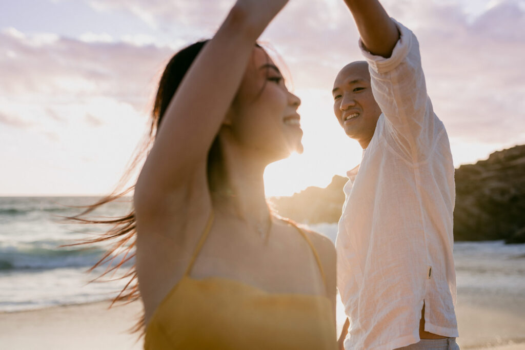 Singapore couple dancing on the beach during their Perth pre-wedding photoshoot at sunset