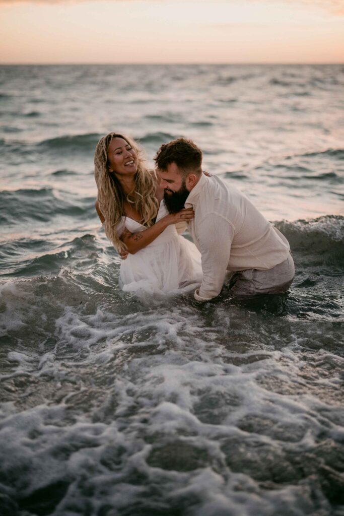 laughter at the elopement taiking portraits in the water