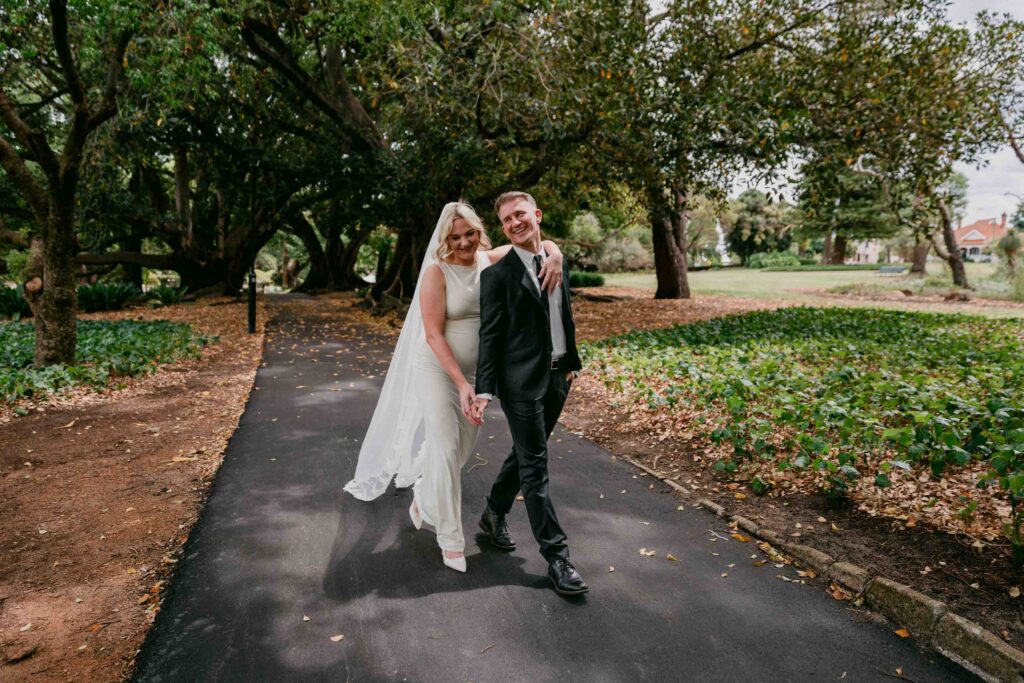 couple happily walking in hyde park after their micro wedding at a nearby church
