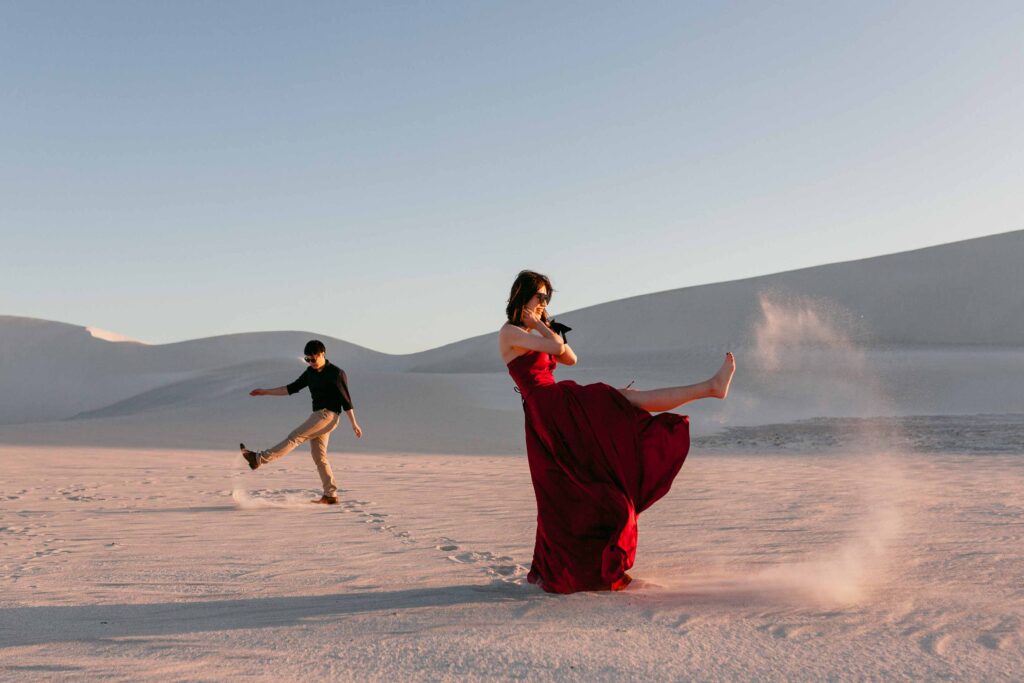 couple kicking the sand at the sand dunes in lancelin for their destination pre-wedding shoot in perth, lancelin