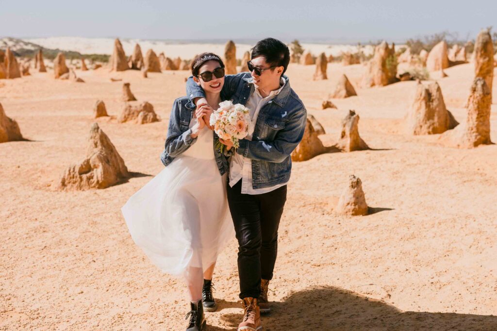 Couple walking through the pinnacles dessert for ther pre-wedding shoot