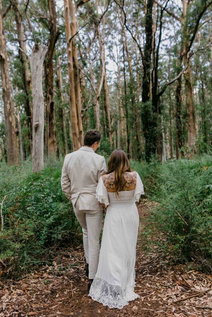 walking into the boranup forest after their elopement in margaret river