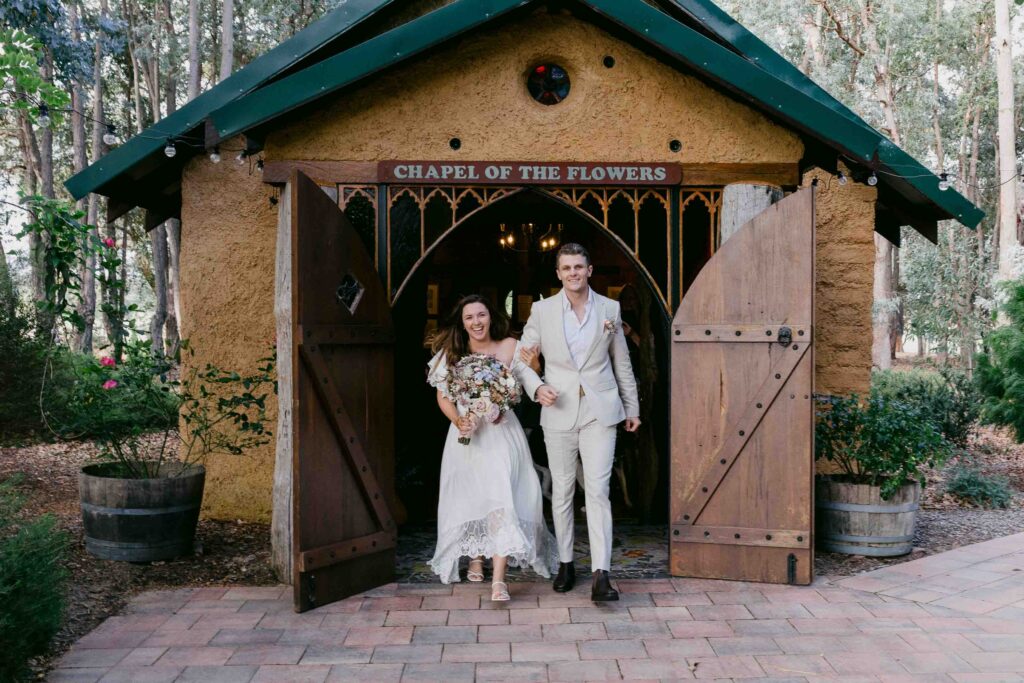 exiting the chape after their elopeement in margaret river