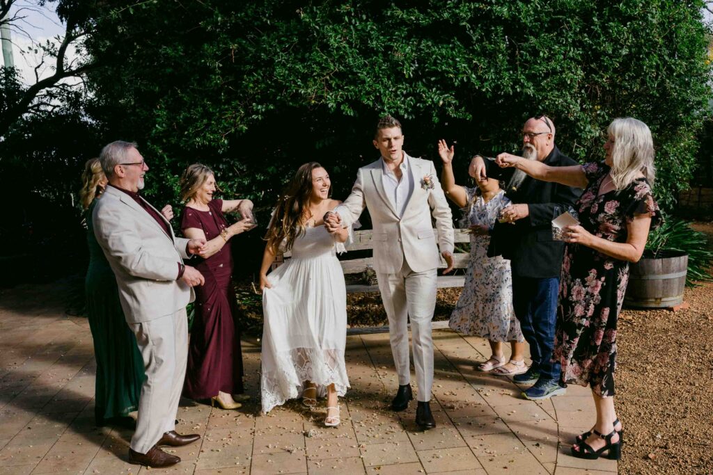 Newlyweds celebrating with family outside a chapel during their Margaret River elopement