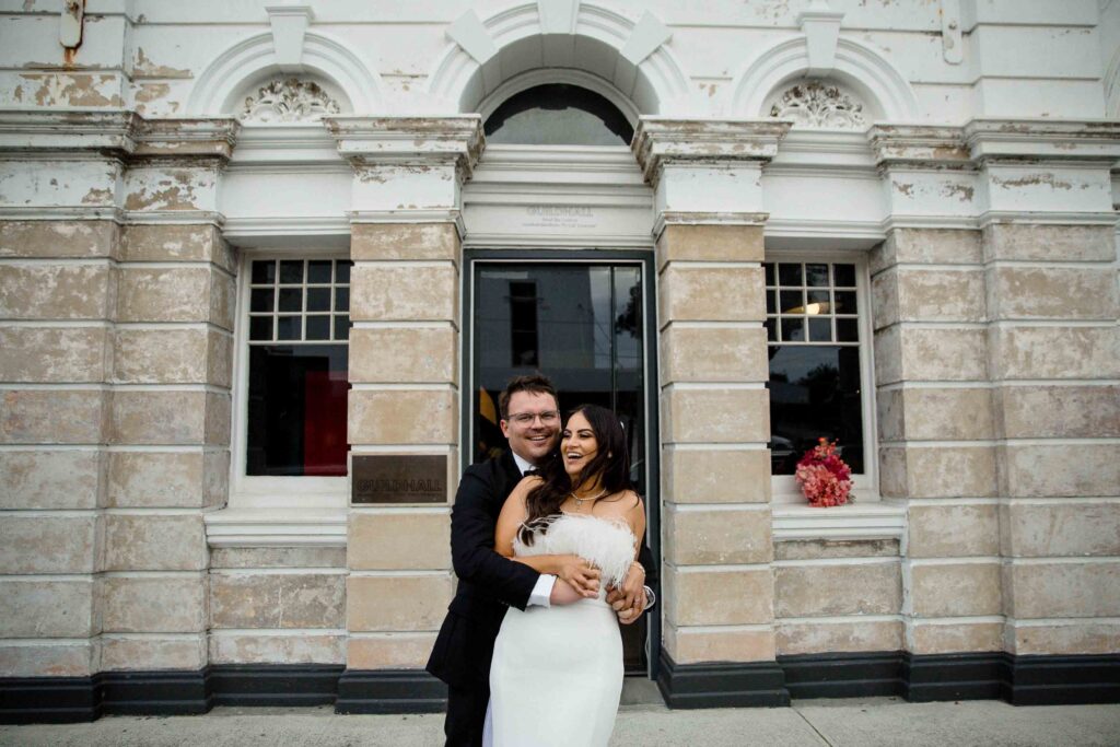 couple poirtait ouside guild hall mice-wedding ceremony