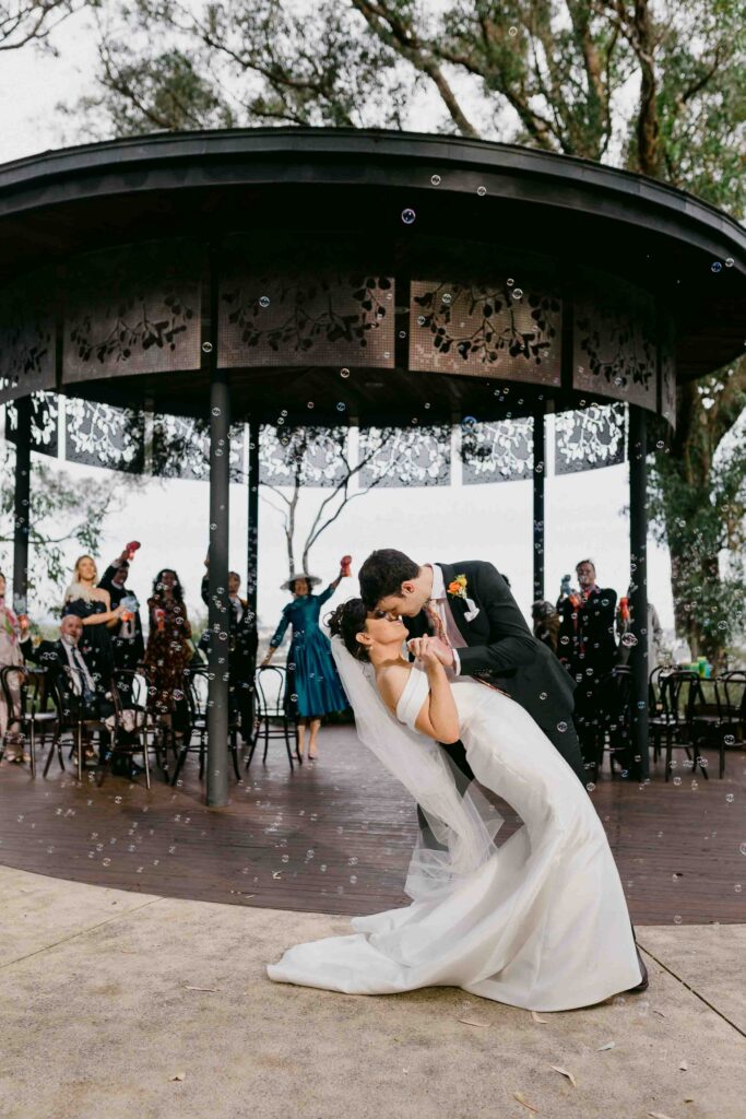 kiss down the aisle after their micro -wedding ceremony