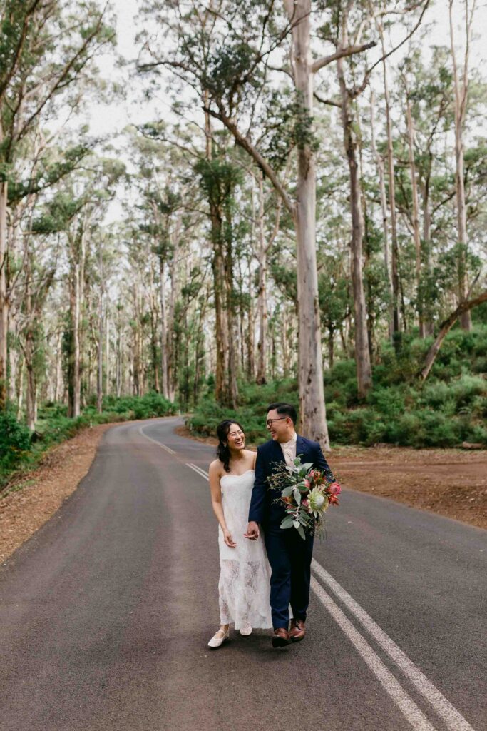 couple walking down cavs road holding hands together couple embracing during their Perth pre-wedding photoshoot.