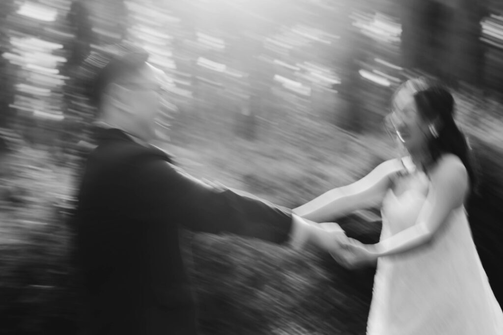 couple spinning in blurry black and white image during their Perth pre-wedding photoshoot.