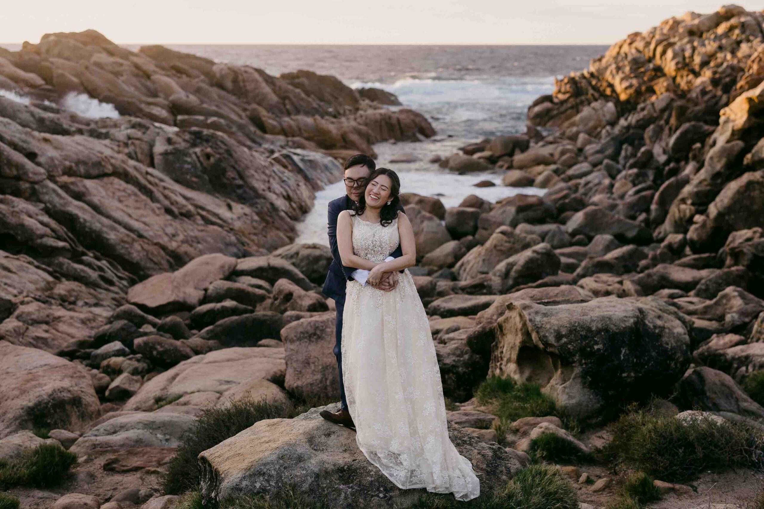 couple holding eachother close at injidup spa couple embracing during their Perth pre-wedding photoshoot.