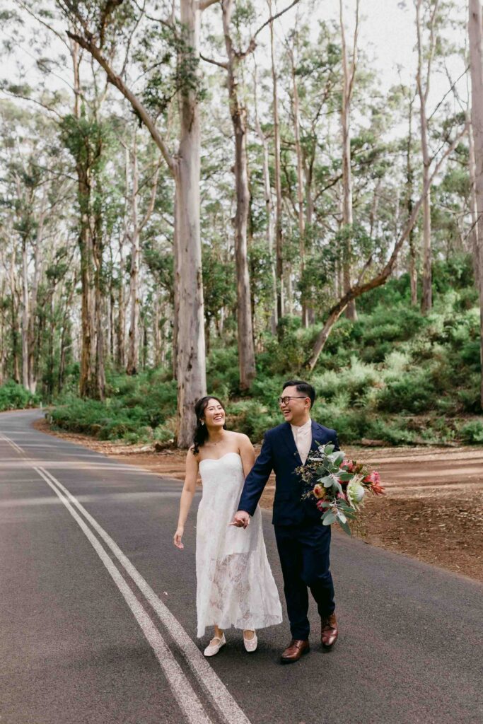 Couple walking together among the karri trees of Boranup Forest