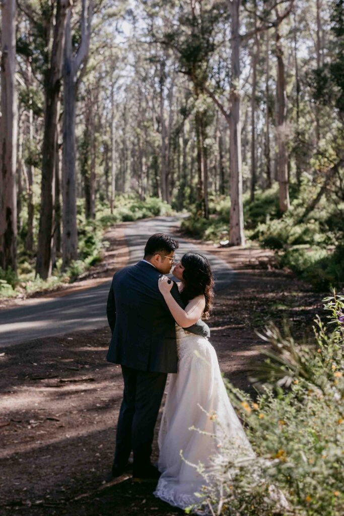 Cadence and Nicholas embracing among the trees in Boranup Forest