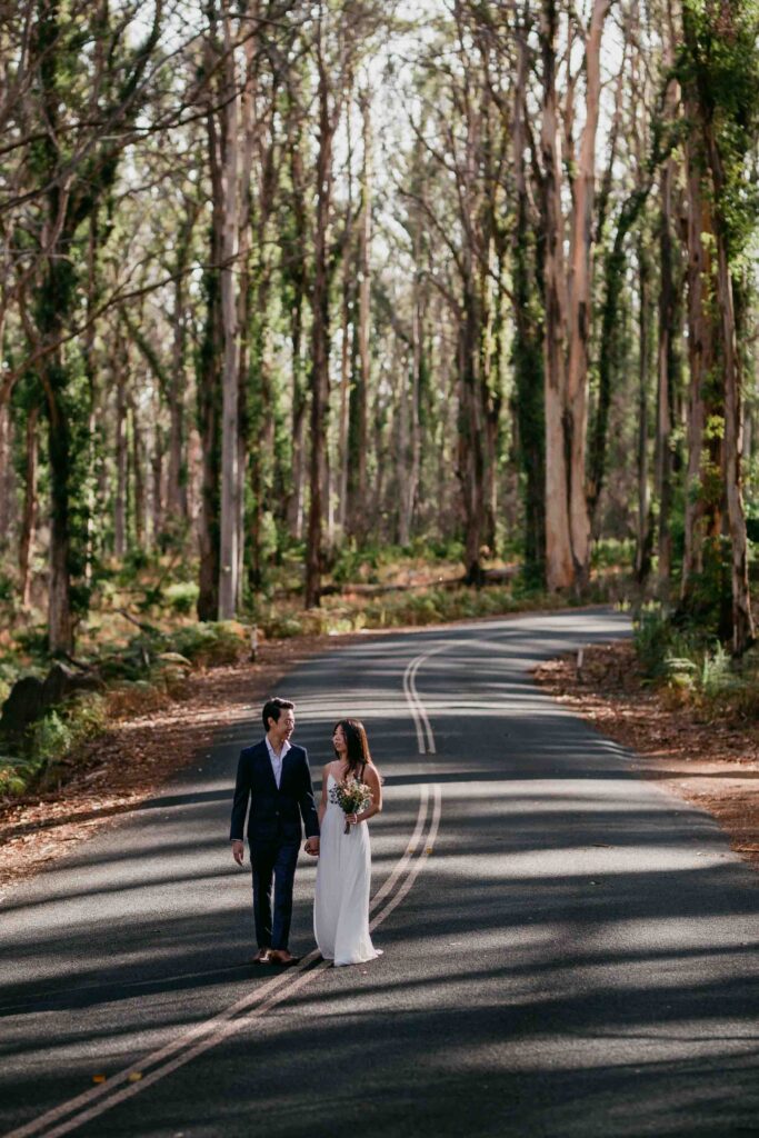 Kenneth and Flora walking together during their Boranup Forest pre-wedding shoot