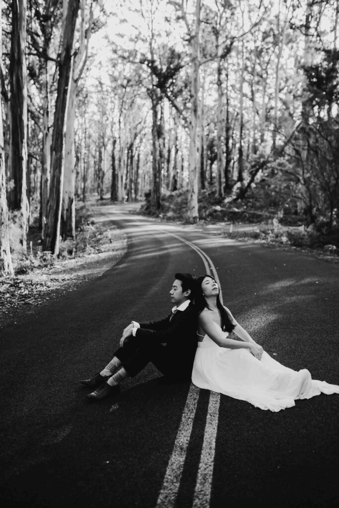 Black and white image of Kenneth and Flora sitting in the middle of caves road enjoying the serenity