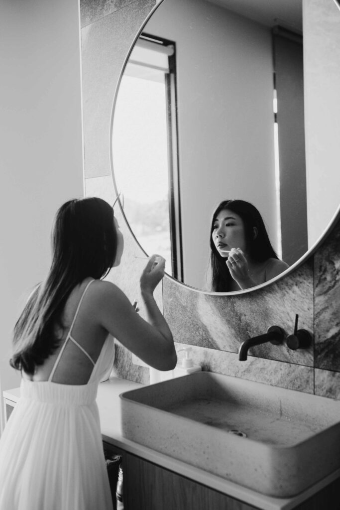 Flora getting make up ready in mirror at 8 paddocks near cowaramup