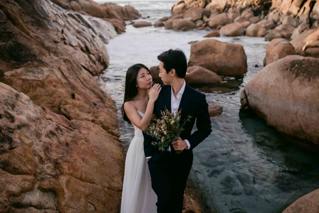 embracing at injidup spa for their pre-wedding photos