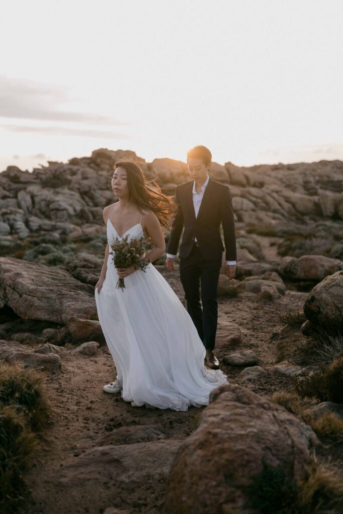 Flora and Kennet walking together to their next location at Injidup spa for their pre-wedding photos