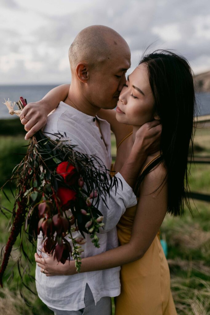 couple embracing with bouquet at injidup spa