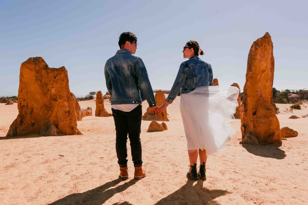 Marco and Rachel surrounded by the golden Pinnacles Desert during their pre-wedding photoshoot