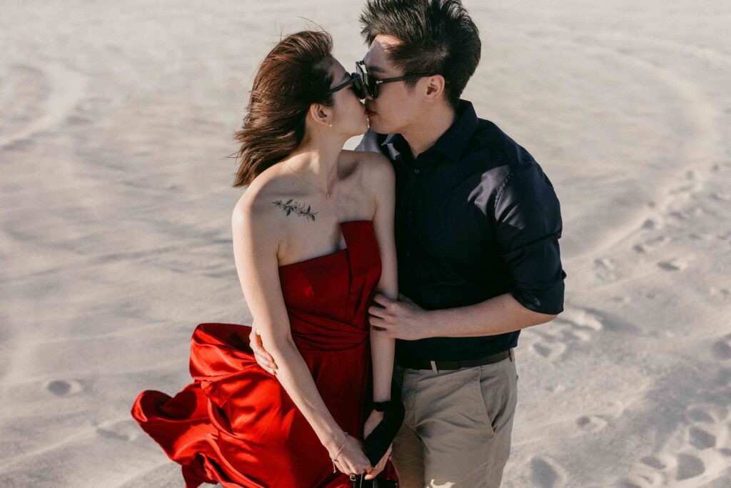 Intimate Lancelin pre-wedding photograph of Marco and Rachel wearing sunglasses in the dunes