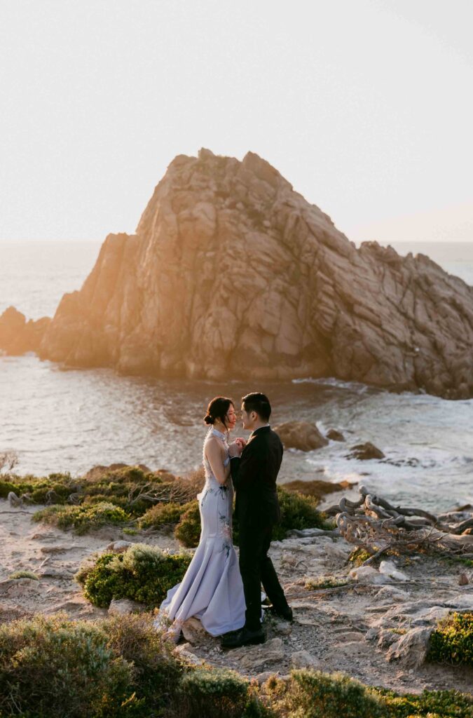 Couple embracing during a windy Sugarloaf Rock sunset shoot