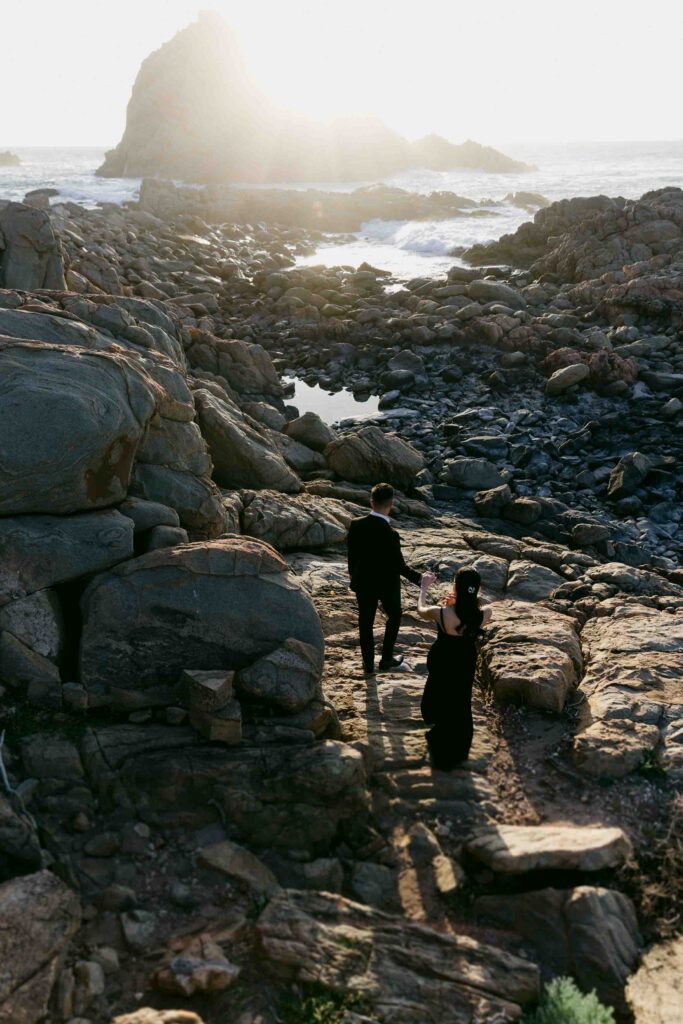 Joey and Davis walking down towards the rocky coastline near Sugarloaf Rock