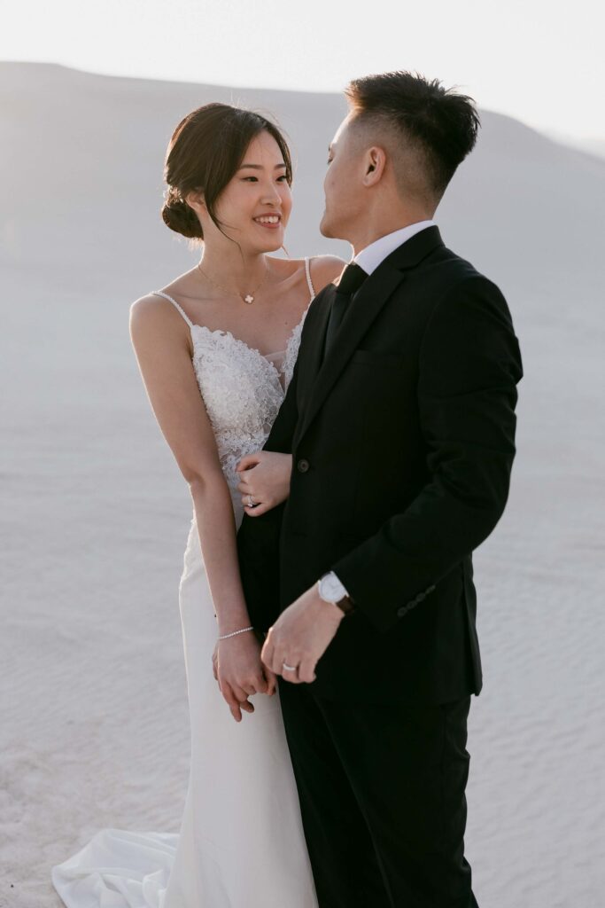 Joey and Davis facing each other across the sweeping white dunes of Lancelin