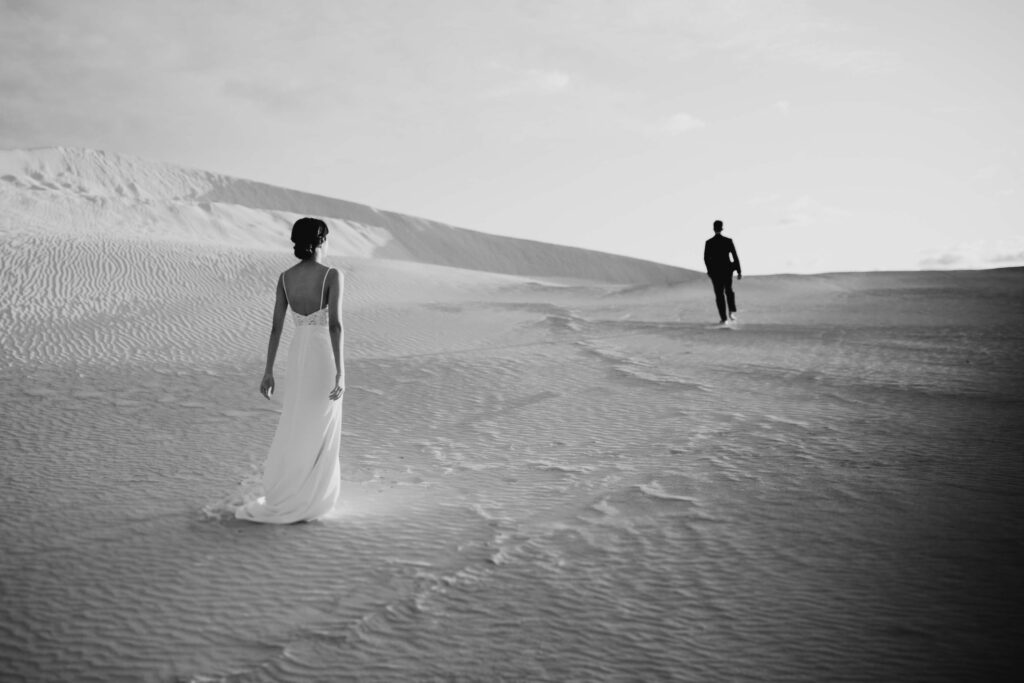 Joey and Davis facing each other across the sweeping white dunes of Lancelin