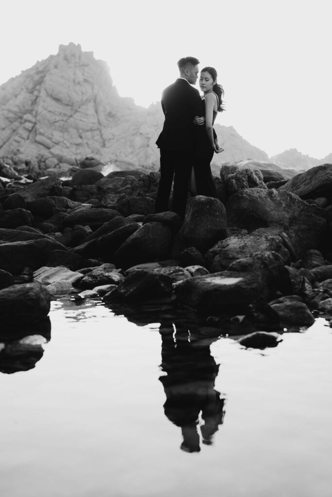 Black and white portrait of Joey and Davis reflected in a coastal rock pool