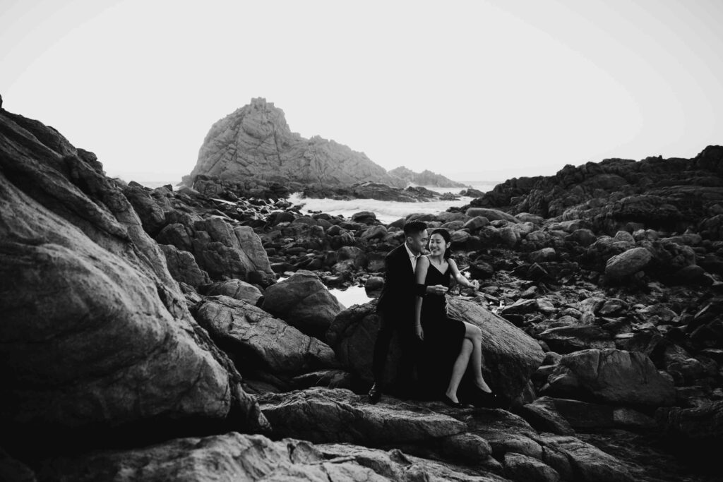 Black and white portrait of Joey and Davis sitting among the rocks near Sugarloaf Rock