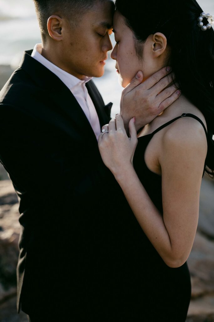 Joey and Davis sharing an intimate embrace during their coastal pre-wedding shoot