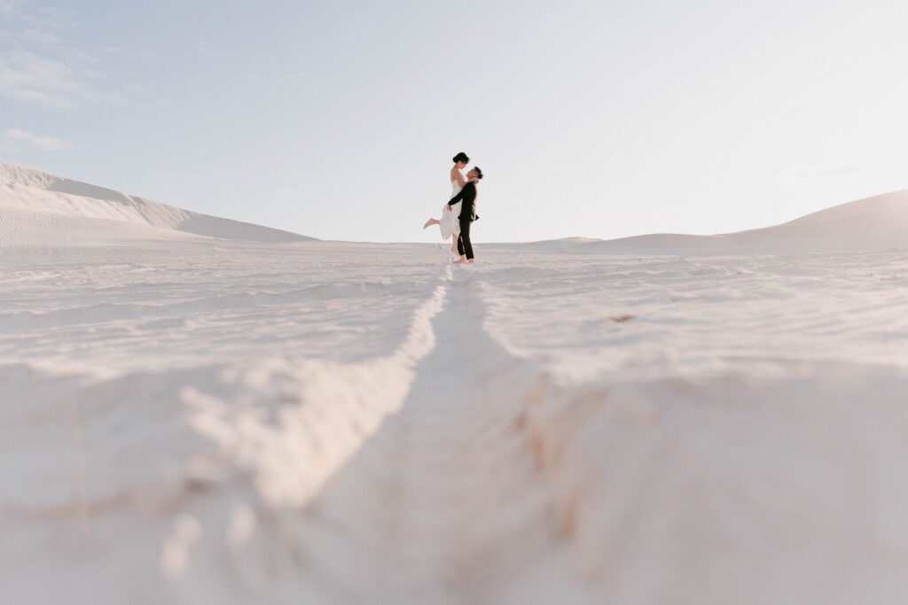 Joey and Davis running towards each other during their Lancelin pre-wedding shoot