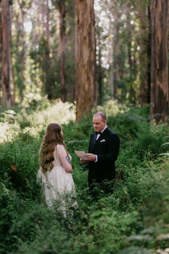 Couple privately exchanging personal vows during a Boranup Forest elopement