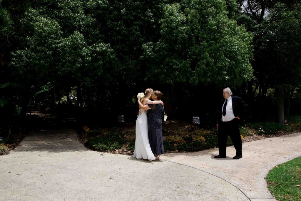 Bride greeting her parents before walkign down the aisle at Kings Park