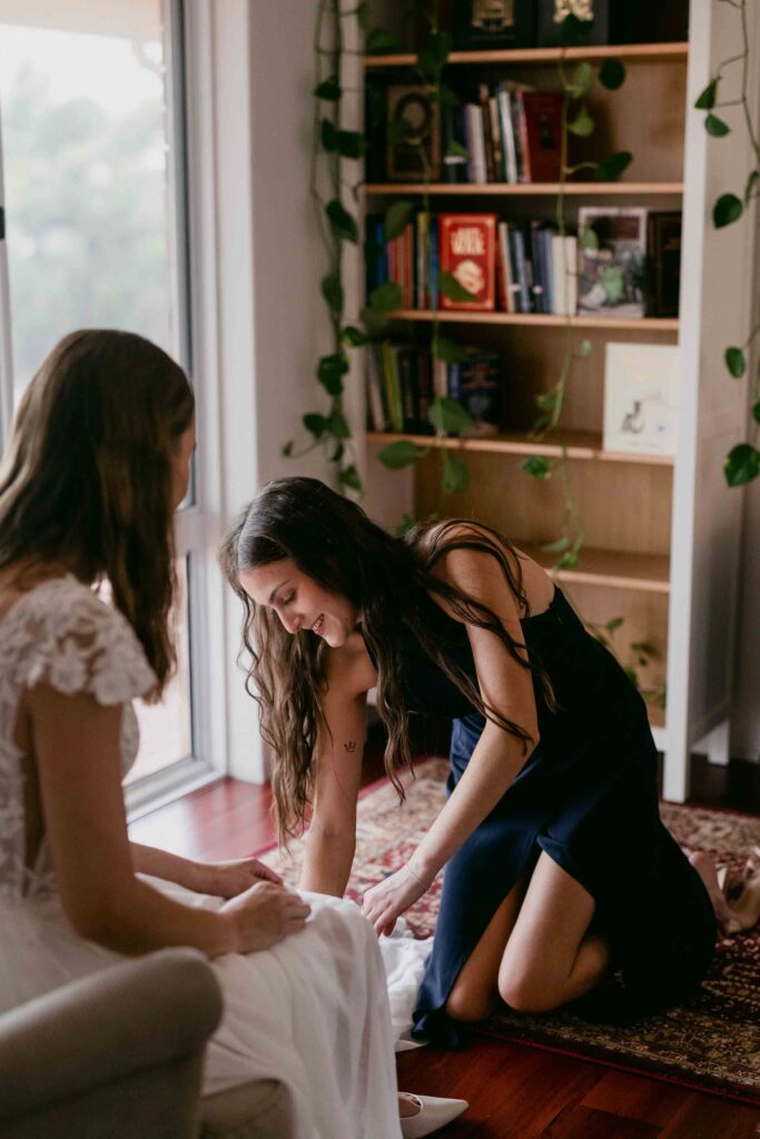 Bride’s niece helping her prepare for an intimate autumn wedding