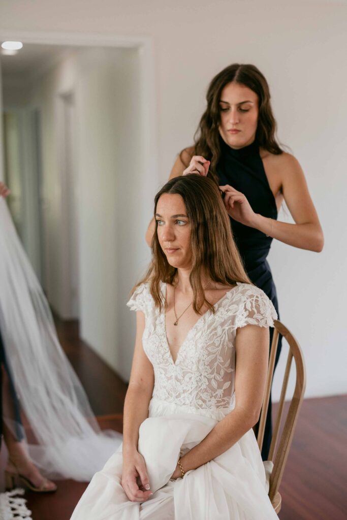 Bride’s niece helping her prepare for an intimate autumn wedding