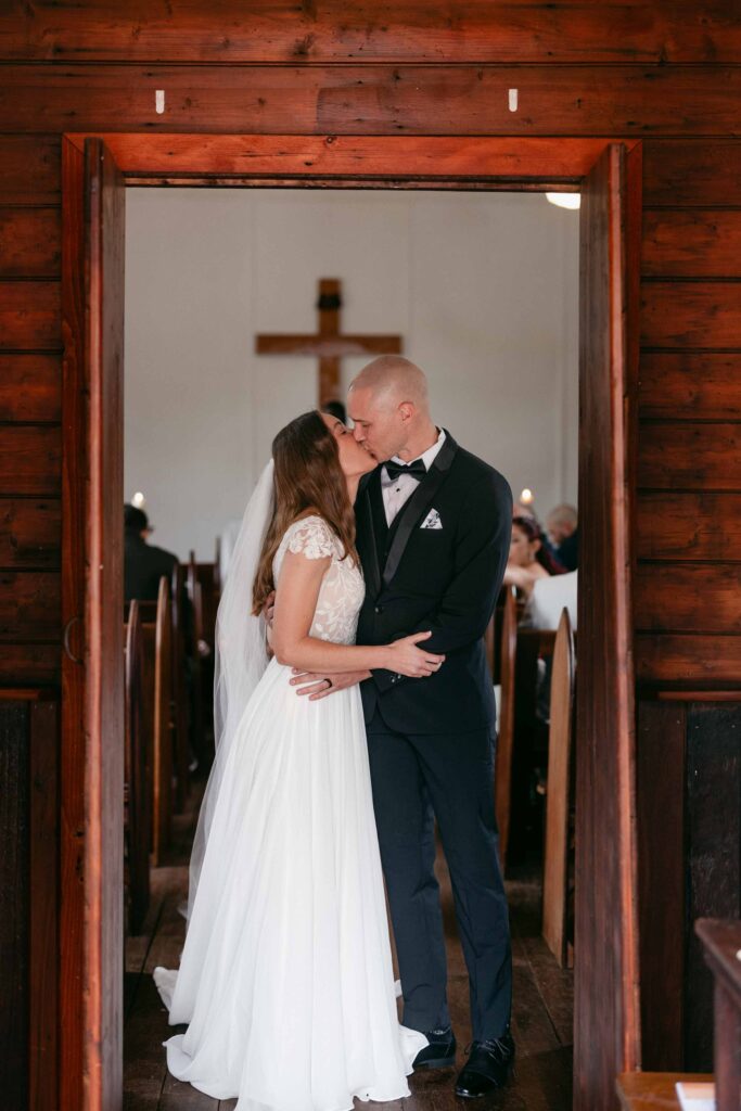 Newlyweds sharing their first kiss inside St Paul’s Anglican Church