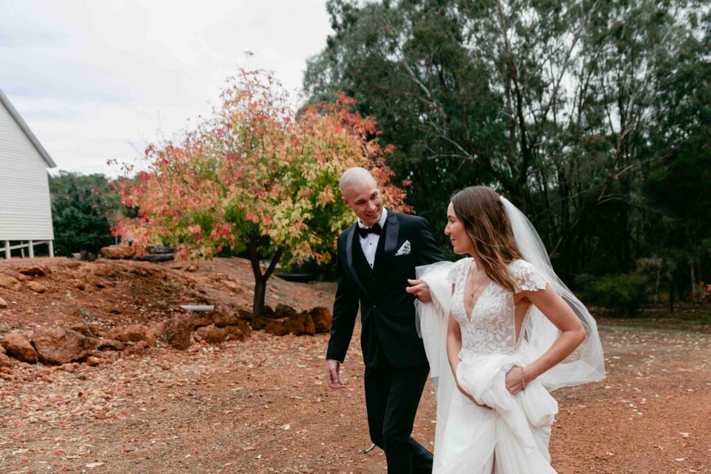 couple walking back to jarrahdale chapel to celebrate with their guestse