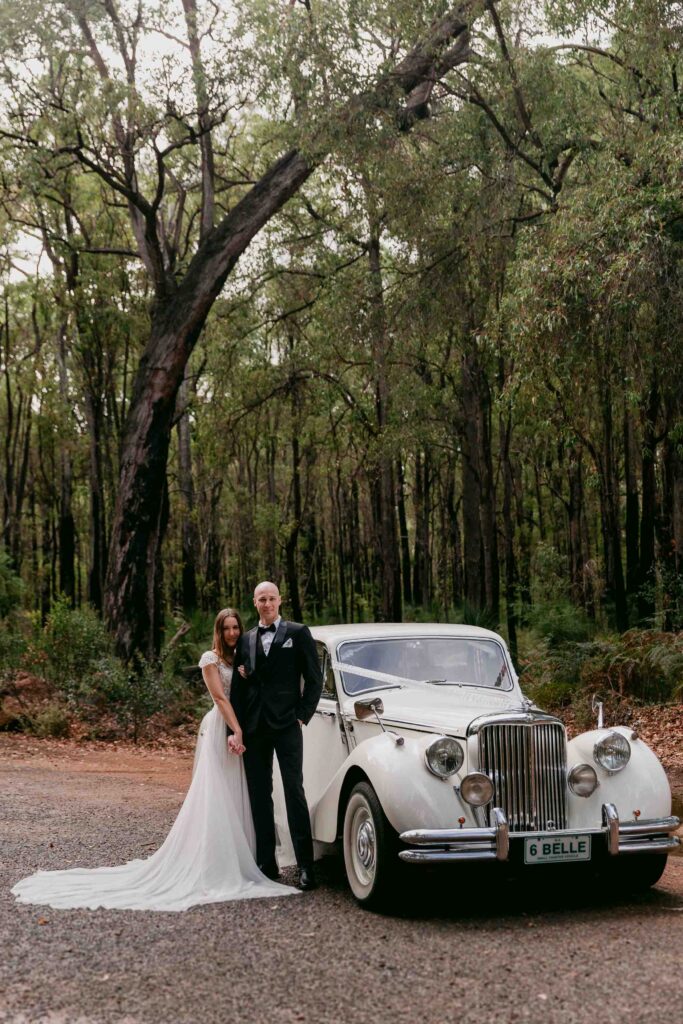 Newlyweds photographed inside a vintage Jaguar wedding limousine