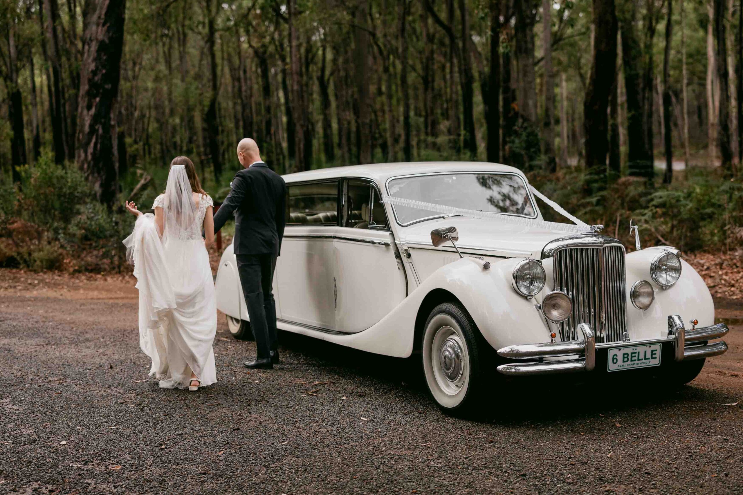 couple walking back to belle limousine to depart