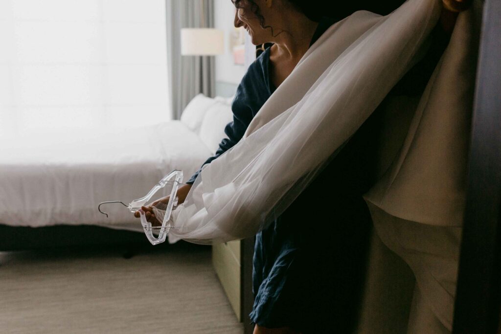 Bride carrying dress ready to get fitted