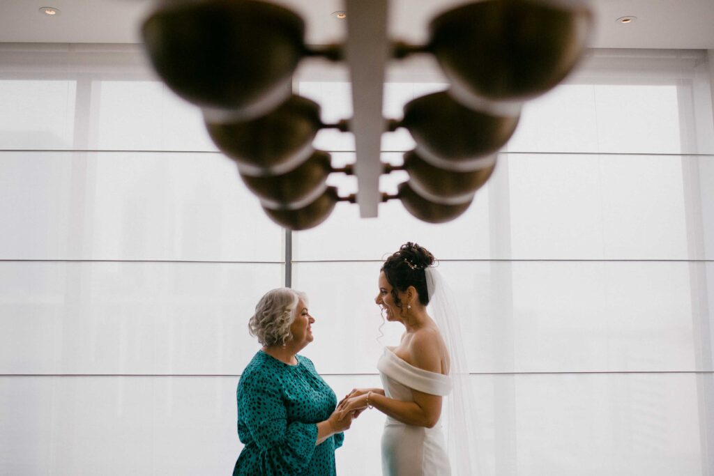 Mother and daughter moments after dads first look and walking down the aisle at Marlee Pavillion for micro-wedding eremony