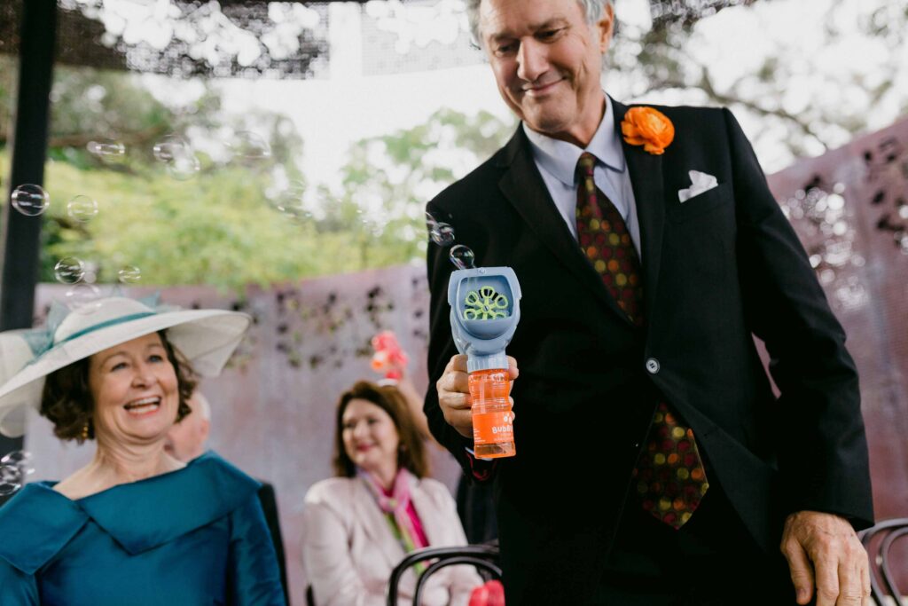 Newlyweds walking through bubbles after their Marlee Pavilion ceremony