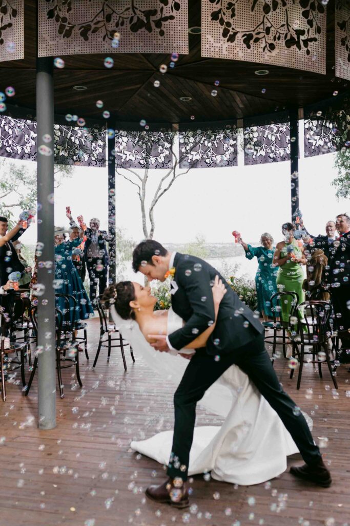 Newlyweds walking through bubbles after their Marlee Pavilion ceremony