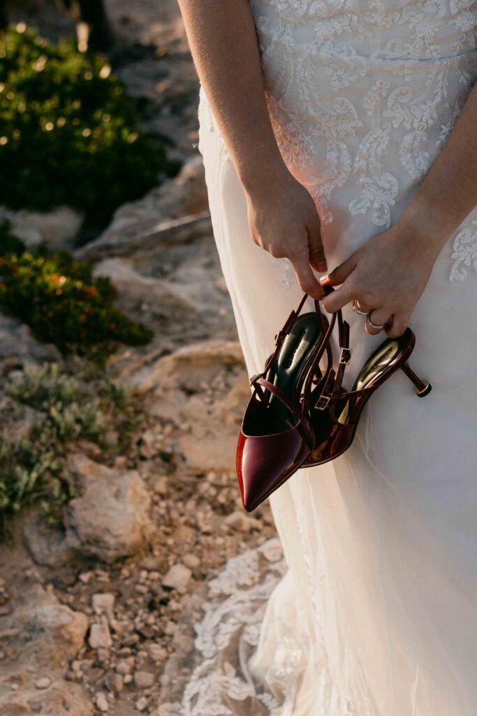 Cadence holding her wedding shoes during her Sugarloaf Rock shoot