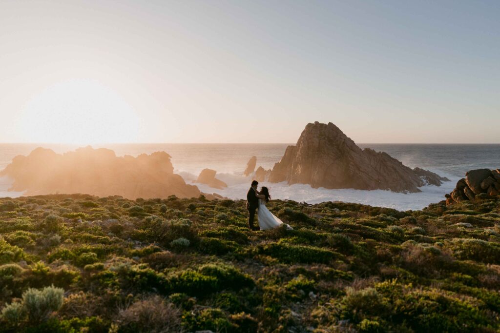 Cadence and Nicholas holding hands during sunset at Sugarloaf Rock